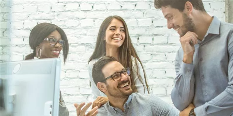Equipo de personas colaborando en una oficina, representando el compromiso laboral y los factores que influyen en la rotación de personal en las empresas.