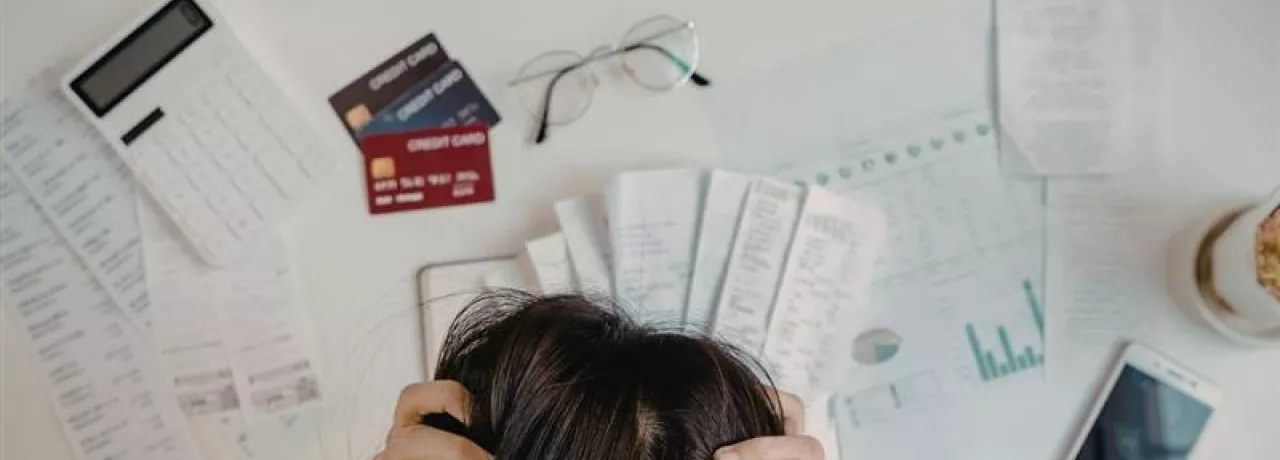 Colaborador revisando sus finanzas en la oficina, ejemplo de cómo el estrés financiero puede afectar el bienestar laboral.