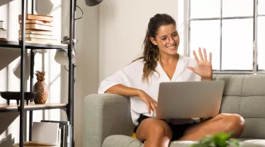 Persona trabajando desde casa en una videollamada, representando el modelo de trabajo híbrido y la flexibilidad laboral.