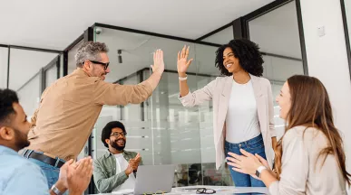 Equipo de trabajo celebra los buenos resultados durante una reunión.